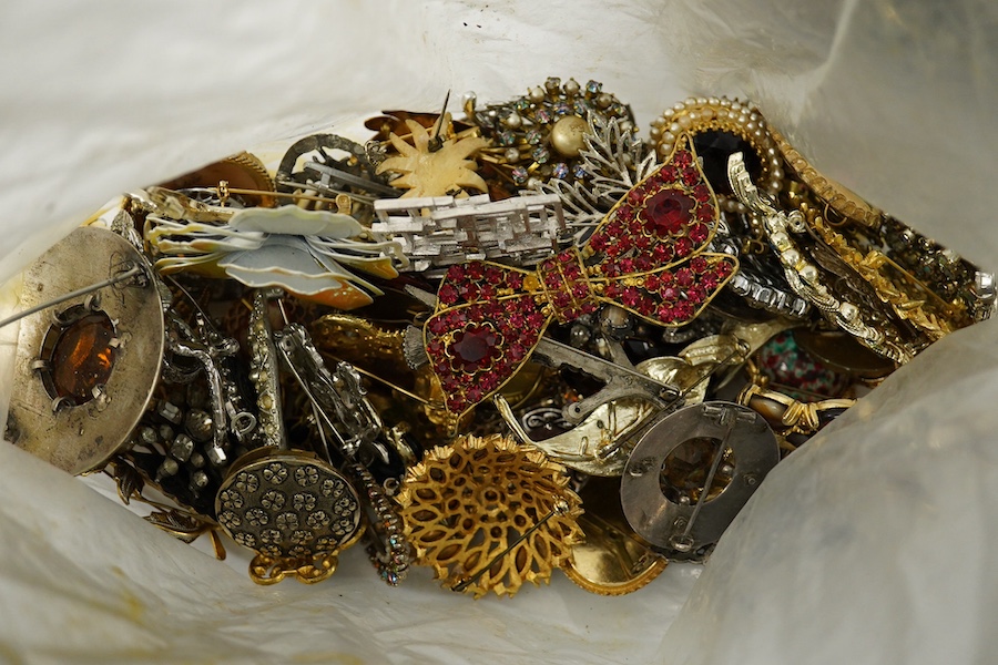 Four large bags of assorted costume jewellery including, brooches, necklaces, bangles, etc. Condition - poor to fair to good